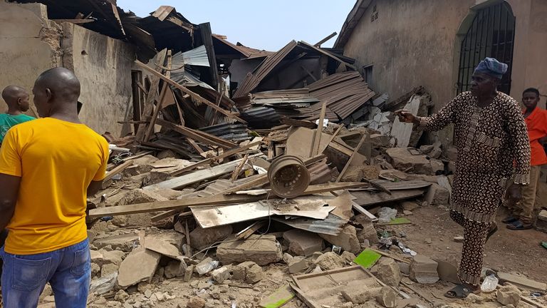 Locals inspect the damage after US strikes supposedly targeting IS militants in Offa, in the Kwara region. Pic: Reuters