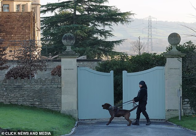 The gates to the lavish Georgian manor appear to be slightly ajar as the fierce patrol dog and the security guard stand guard