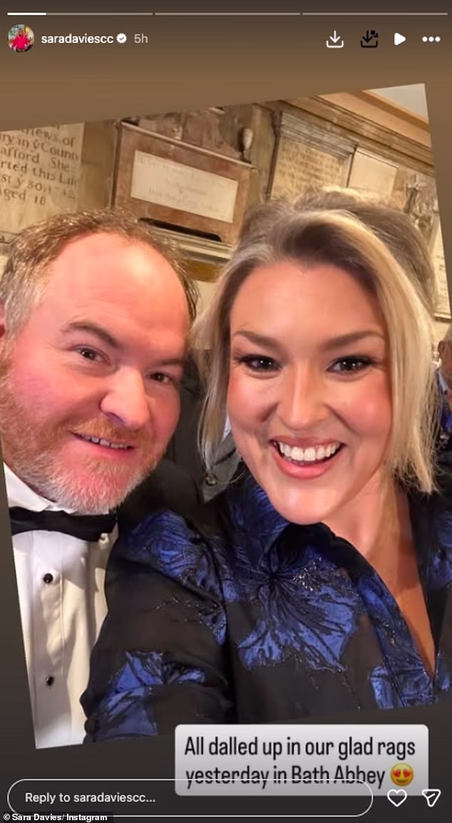 She was joined by her husband Simon and wore a pretty blue and black flower patterned dress for the wedding