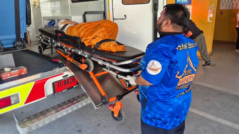 The woman, who was thought to be dead, is taken to hospital after being found to be alive at the crematorium. Pic: AP