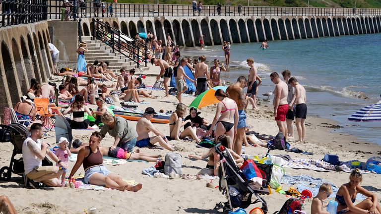 People enjoy the warm weather in Folkestone, Kent, in July. Pic: PA