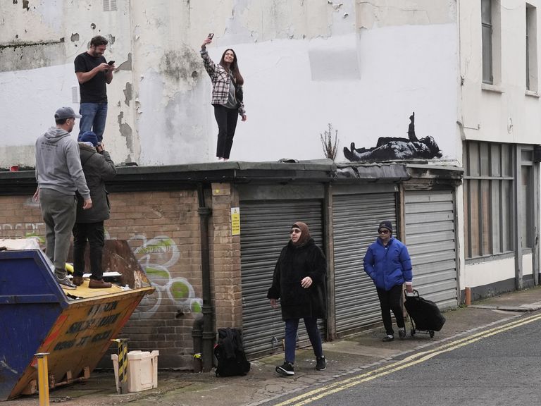 A piece of graffiti artwork depicting two children by street artist Banksy, in Bayswater in central London. Pic: PA