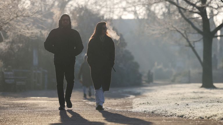 People walk past frosty grass in Queen's Park, London. File pic: Reuters