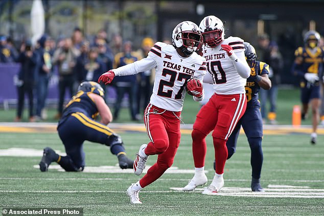 Texas Tech cornerback Amier Boyd (center) intercepts the ball in the win against West Virginia