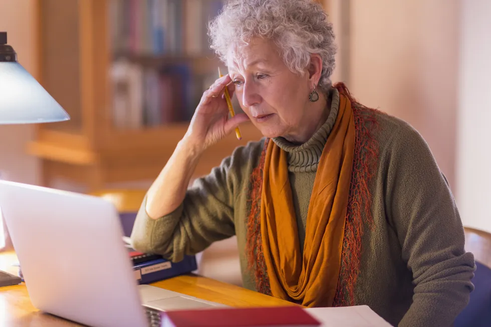 Stock image of woman looking worried at laptop