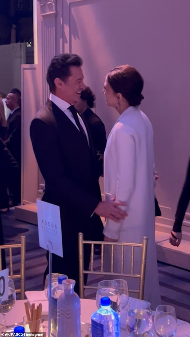 In video obtained by The Daily Mail, Jackman stroked Sutton's arms as they convened inside the soiree