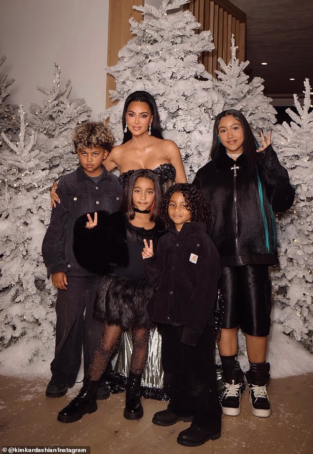 Kim Kardashian, 45, shared a rare portrait with all four of her children for memorable Christmas snaps - but there was no sign of her ex-husband Kanye West