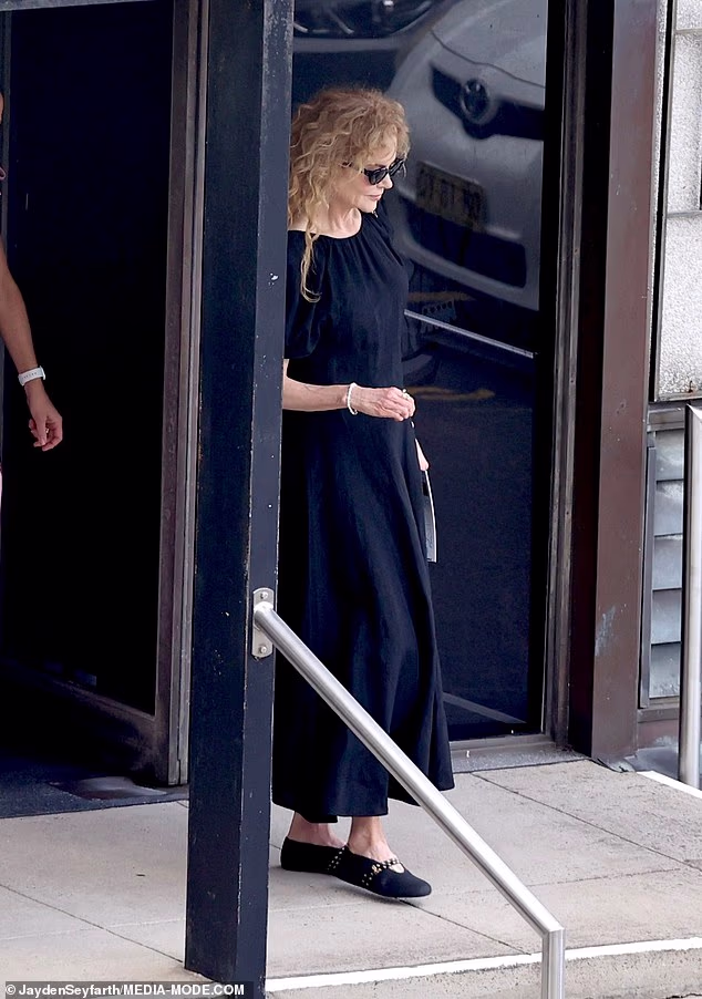Nicole Kidman cut a solemn figure as she stepped out alone for Christmas morning mass in North Sydney on Thursday