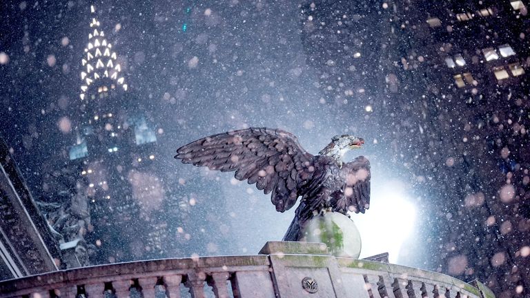 The Chrysler Building rises behind Grand Central Station as snow falls during a winter storm in New York City. Pic: Reuters
