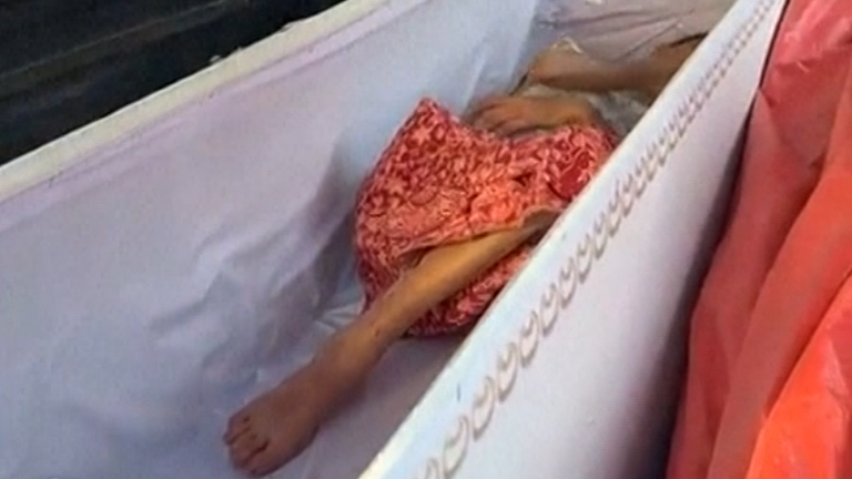 The woman in her coffin. Pic: AP