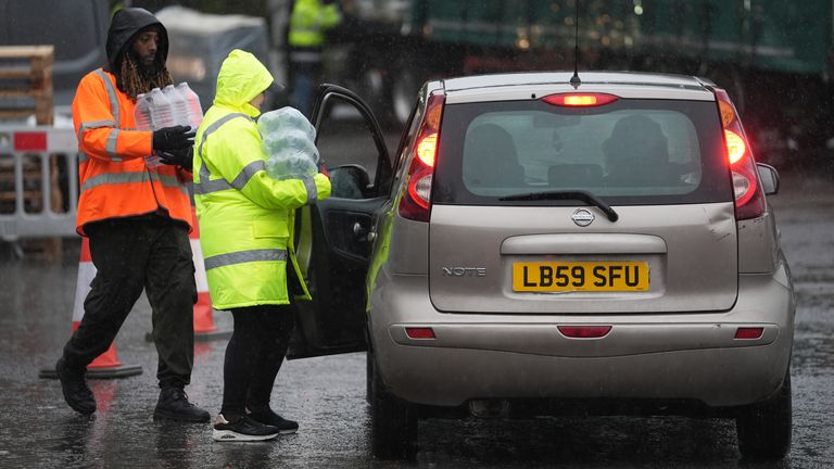 South East Water staff hand out bottled water. Pic: PA