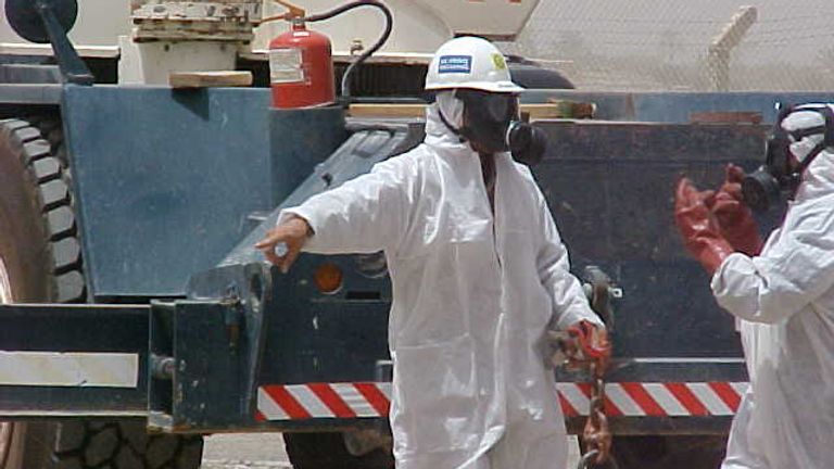 Workers appeared wearing hazmat suits and respirators and put up the warning sign. Pic: Andy Tosh