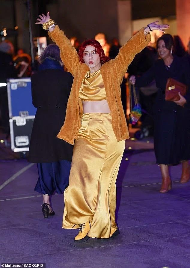 Jessie put on a very colourful display as she slipped into a yellow silk skirt, yellow boots and an orange fur jacket