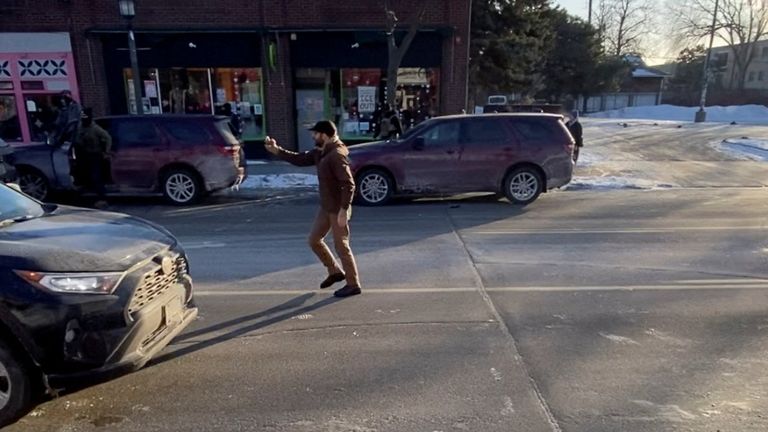 Alex Pretti is seen using a mobile phone moments before he is fatally shot. Pic: Reuters