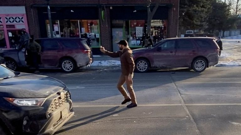 Mr Pretti is seen using a mobile phone moments before he was fatally shot