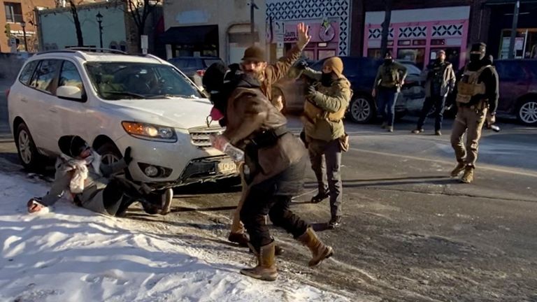 A law enforcement officer spraying irritants at a man identified as Alex Pretti, before he is shot and killed. Pic: Reuters