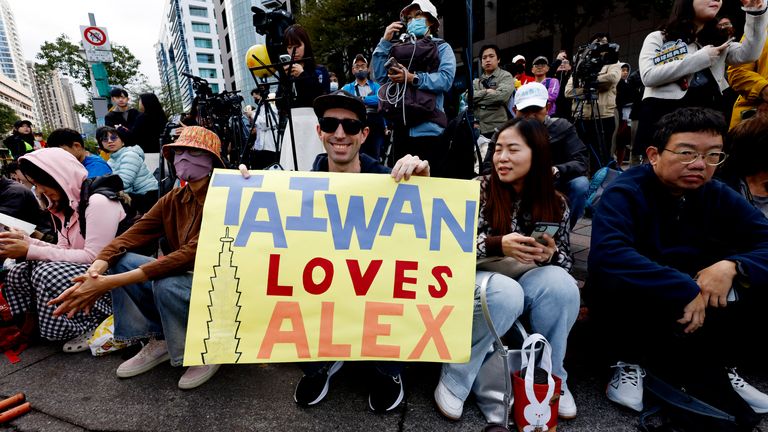 Supporters gathered on the street to witness Honnold complete the ascent. Pic: Reuters