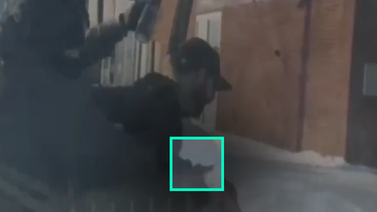 Alex Pretti with his phone in his hand. 