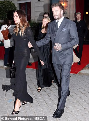 Victoria was seen walking ahead of the former footballer as they emerged from their hotel