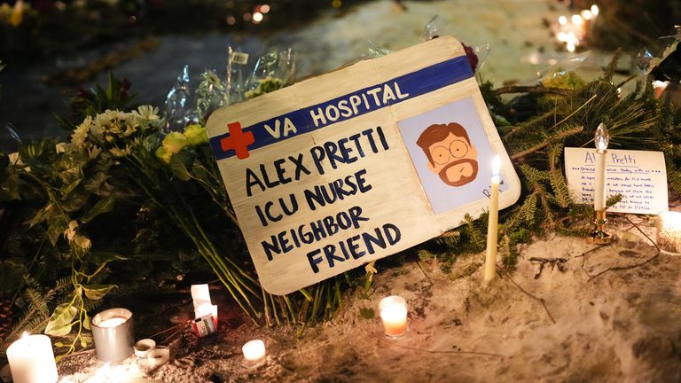 A sign for 37-year-old Alex Pretti is displayed during a vigil. Pic: AP