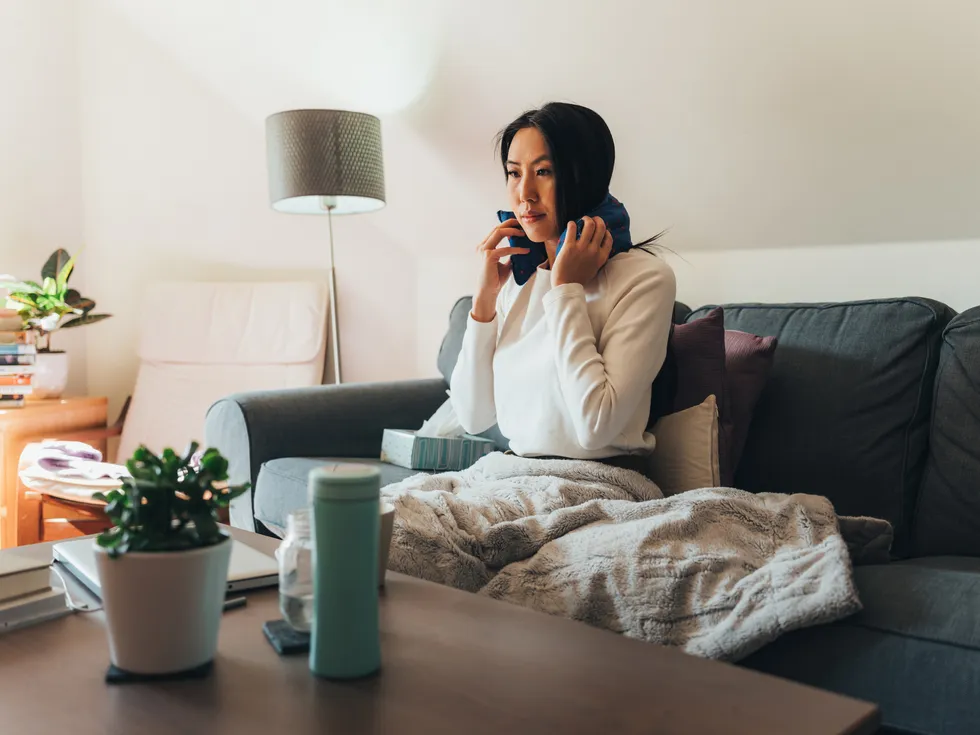Electric blanket being used by person sitting on sofa