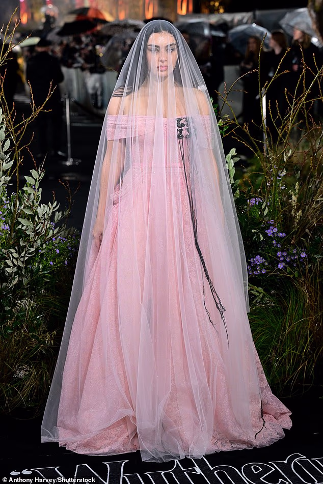 Charli XCX stunned in a pink bridal-esque Erdem gown and veil as she made an early arrival for the star-studded premiere