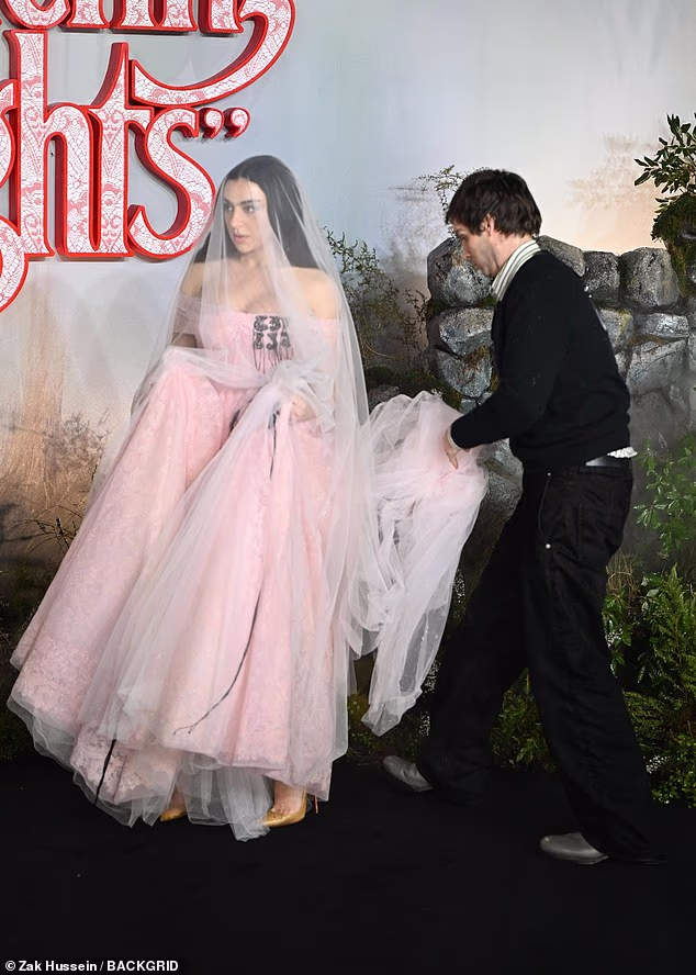 Her dress boasted a voluminous skirt that needed a helping hand as Charli made her way along the black carpet