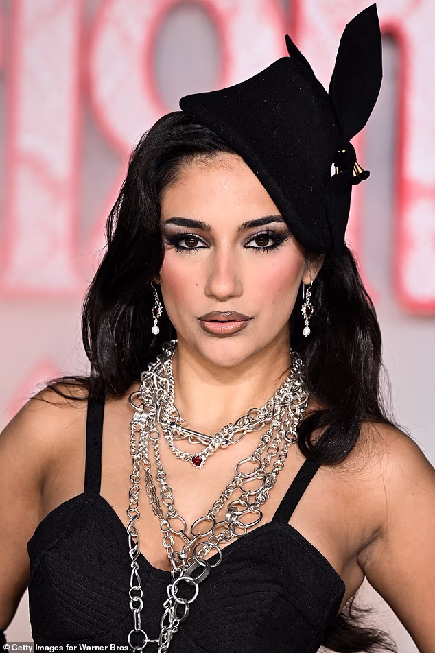 The reality star teamed her outfit with a dramatic matching headpiece and layers of chunky silver jewellery