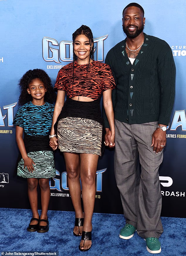 Wade also accompanied the pair during the lighthearted festivities as he sported a dark green cardigan as well as light gray trousers