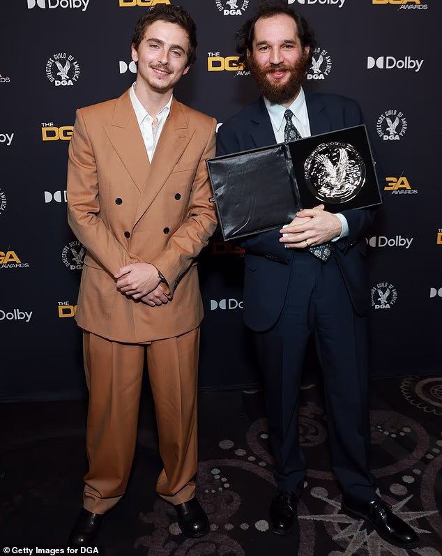 The pair were seen mingling backstage at the Beverly Hilton after the filmmaker accepted the award