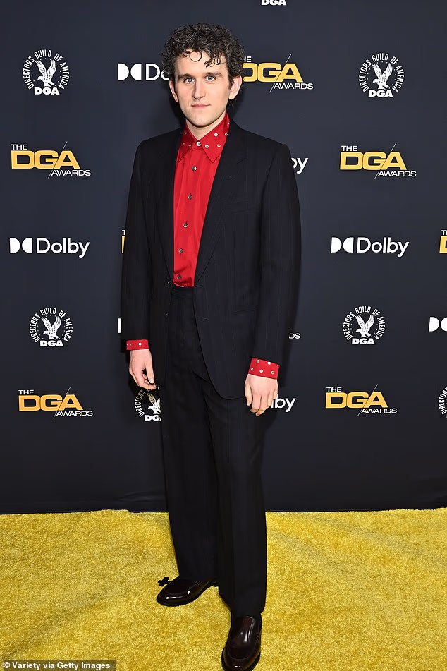 Harry cut a smart figure for the evening in a bold red studded shirt which he teamed with a black blazer and matching trousers