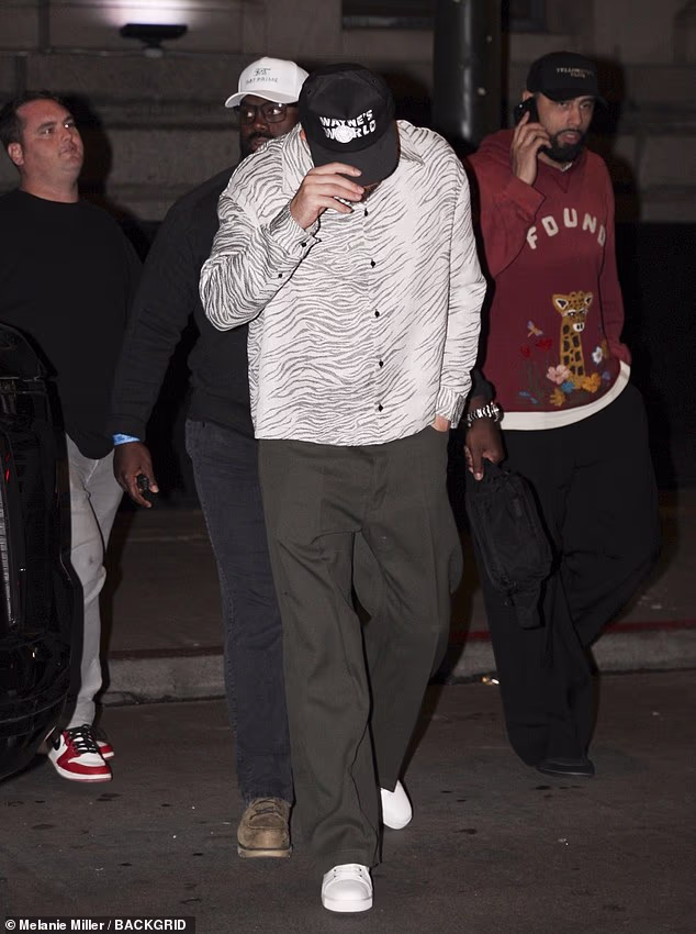 The 36-year-old Kansas City Chiefs tight end sported a black Wayne's World cap with a zebra-print blouse and olive-green trousers