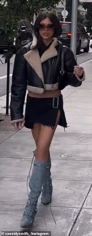 Green flashed her taut tummy and thighs in a split mini-skirt, cropped shearling jacket and blue knee-high boots