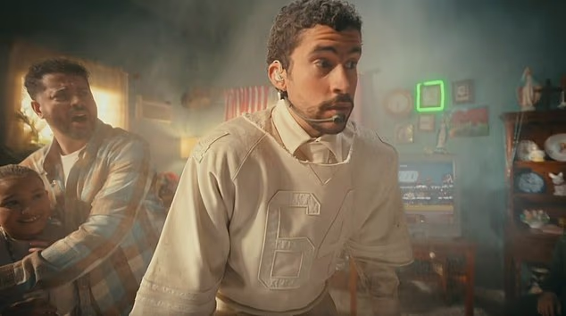 In a hilarious pretaped segment, Bad Bunny appeared to fall through the building roof into the living room of a shocked family