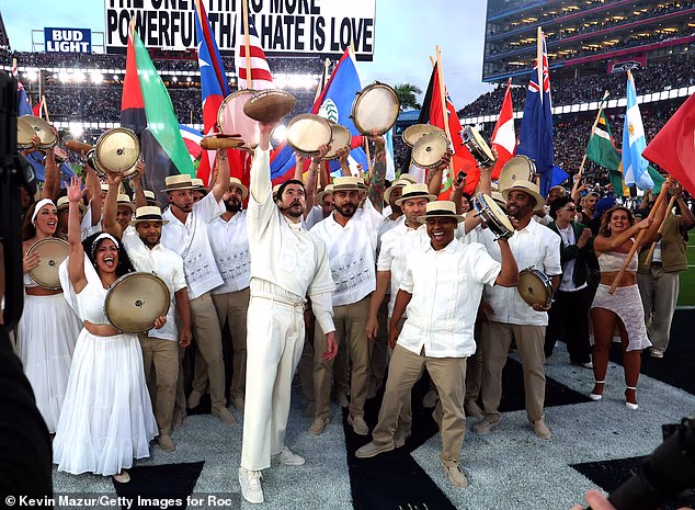 He passed off the flag and shouted 'God bless America!' before reciting the names of Latin American countries that many immigrants in the US hail from, adding the US and Canada and his 'motherland,' Puerto Rico, at the end