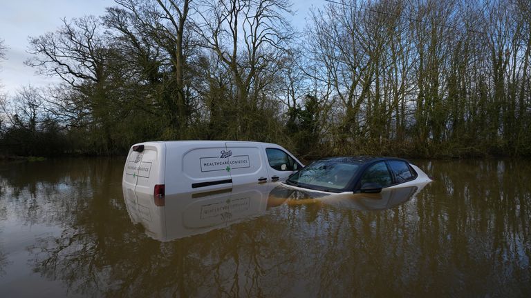 Vehicles left abandoned in a flooded ford in Watery Gate Lane, Thurlaston, Leicestershire. Pic: PA