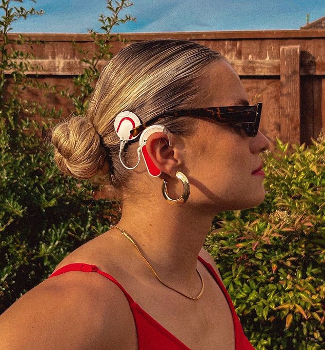 Jodie is pictured showing her cochlear implant - an electronic device for severe to profound hearing loss that bypasses damaged parts of the inner ear (cochlea) to directly stimulate the auditory nerve, providing sound signals to the brain