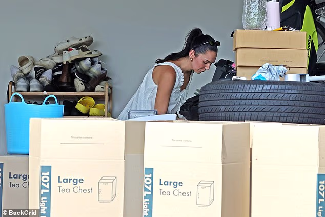She could be seen in the home's garage, packing up large 'tea chest' removal boxes from Bunnings Warehouse