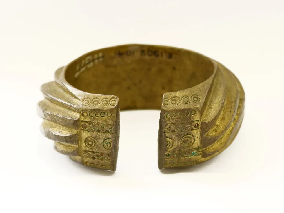 Benin Bronzes: \u200bA brass penannular bracelet decorated with heavy slanting bands