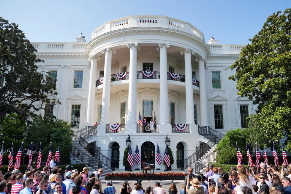 \u200bPresident Donald Trump appears on a balcony next to the first lady Melania Trump