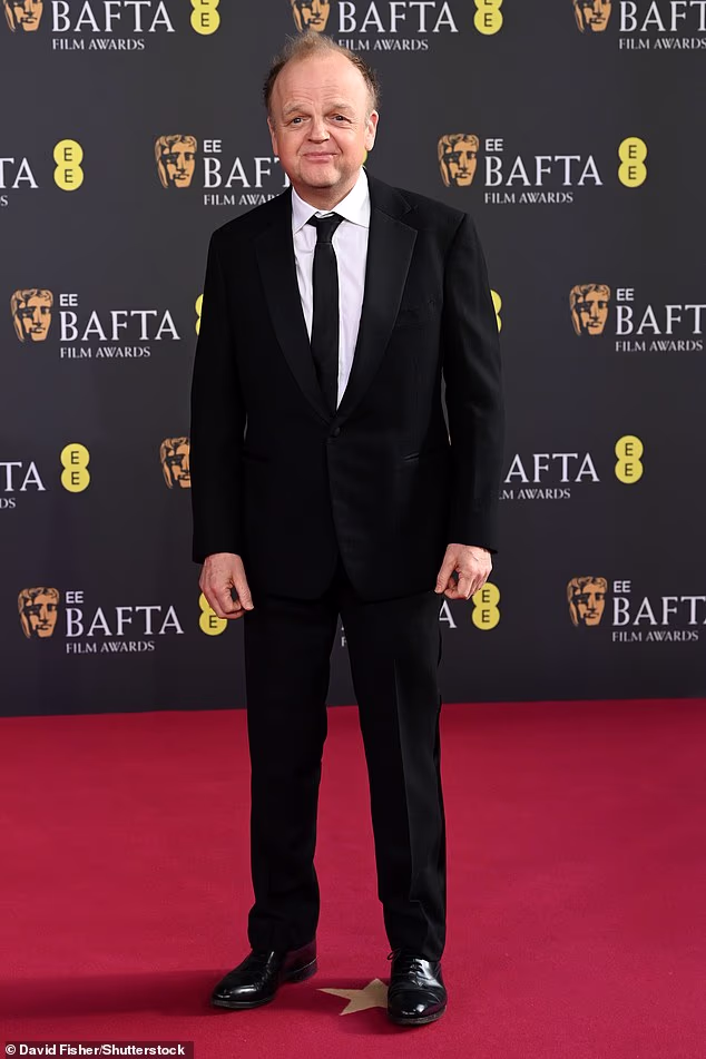 Toby Jones cut a dapper figure in a black suit