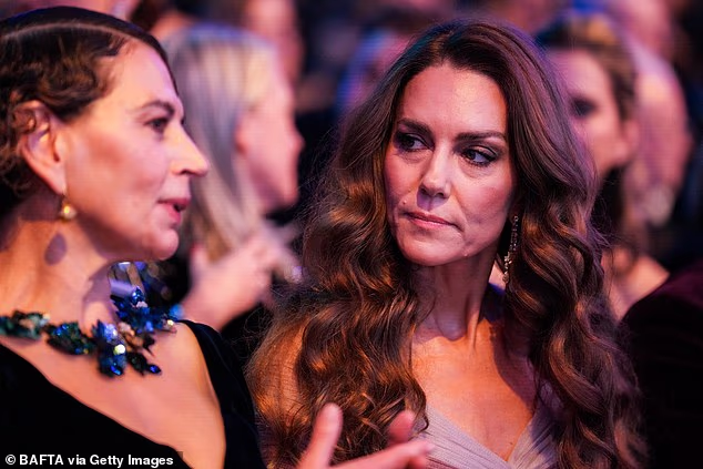 Princess Kate (right) seen speaking with Dame Donna (left) who is the first British woman to run a major Hollywood studio