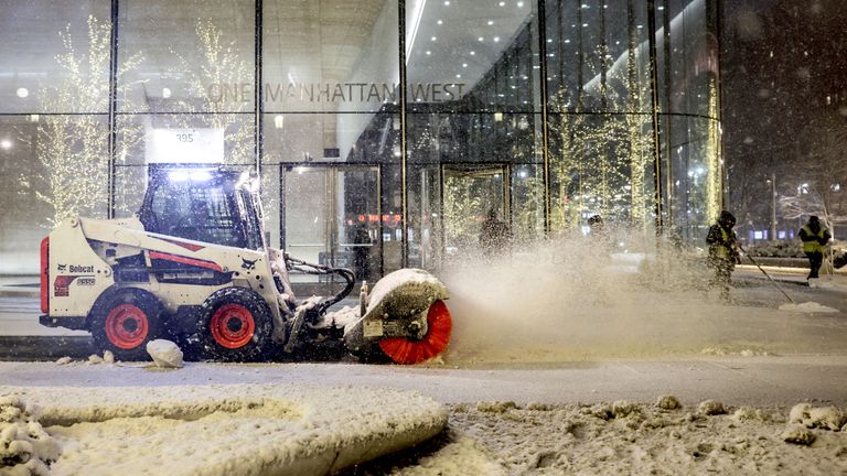 A snow plow vehicle clears the way. Pic: Reuters