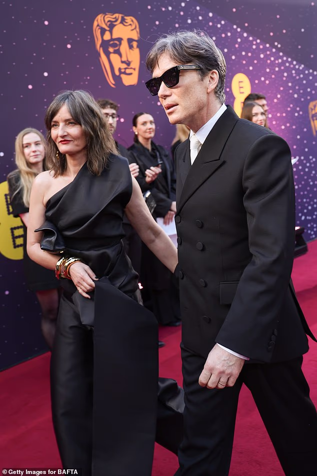 Cillian looked as dapper as ever in a tailored double-breasted blazer, with a white collared shirt and tie and shiny dress shoes