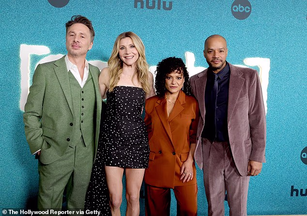 Faison cut a dapper figure in a plum velvet suit with a black button-up shirt and a black tie