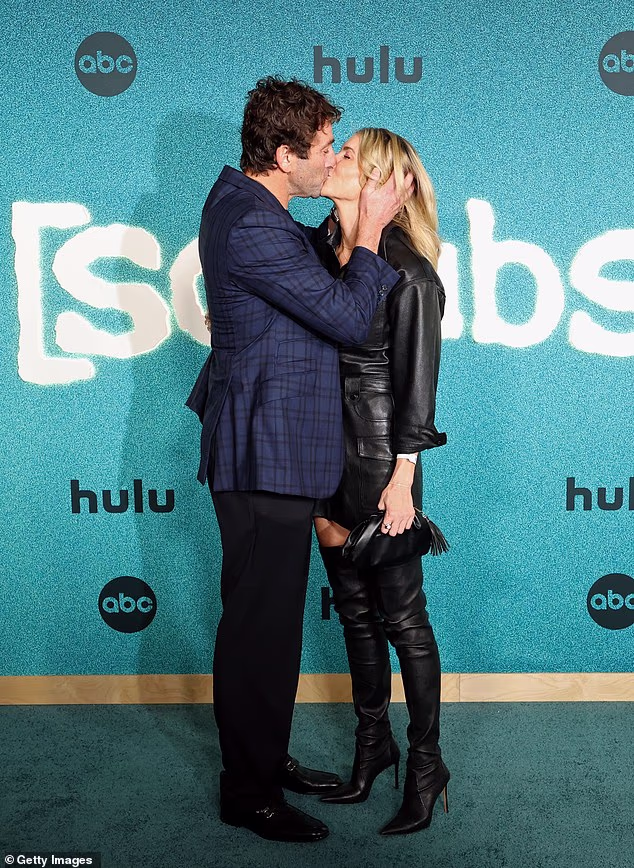 The couple shared an amorous kiss in front of the photographers
