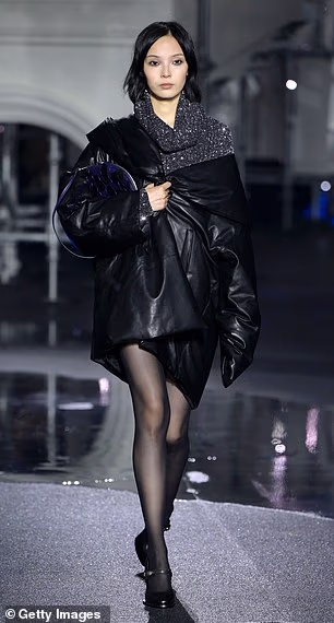 One model showed off a padded black jacket and glittery knit