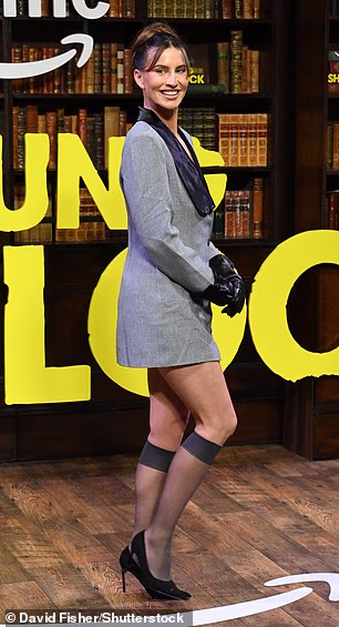 She showed off her chic sense of style in a fun grey blazer mini dress