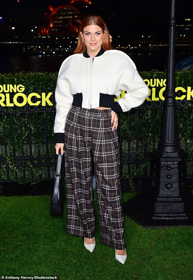 Ashley James cut a chic figure in tartan flared trousers and a cropped white jacket
