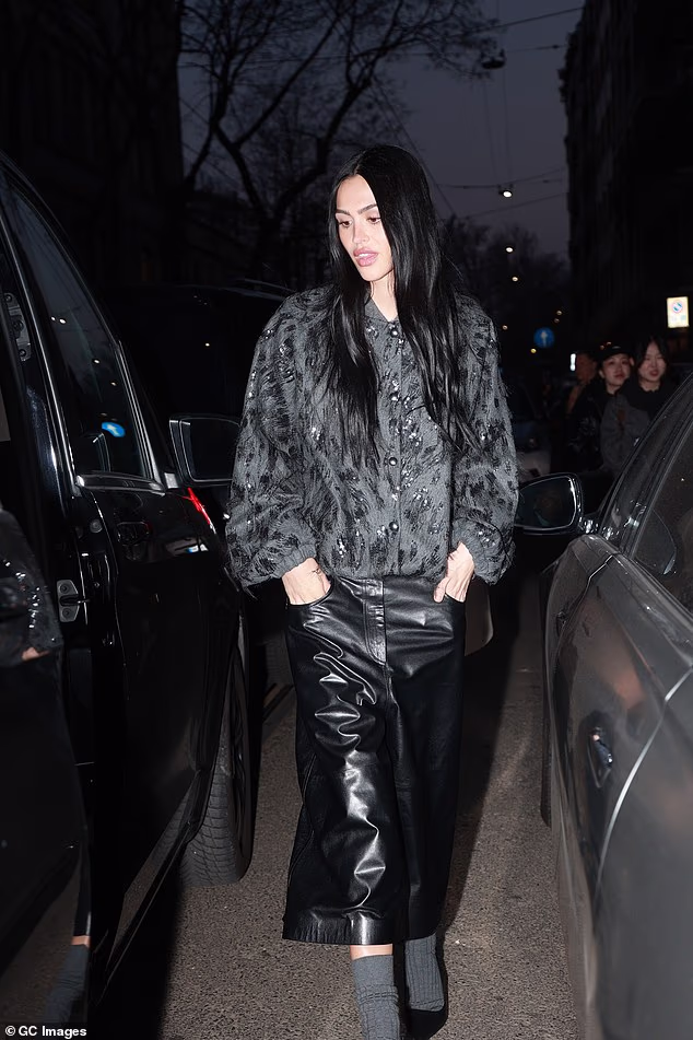 She accessorised with a pair of grey socks and added stiletto heels